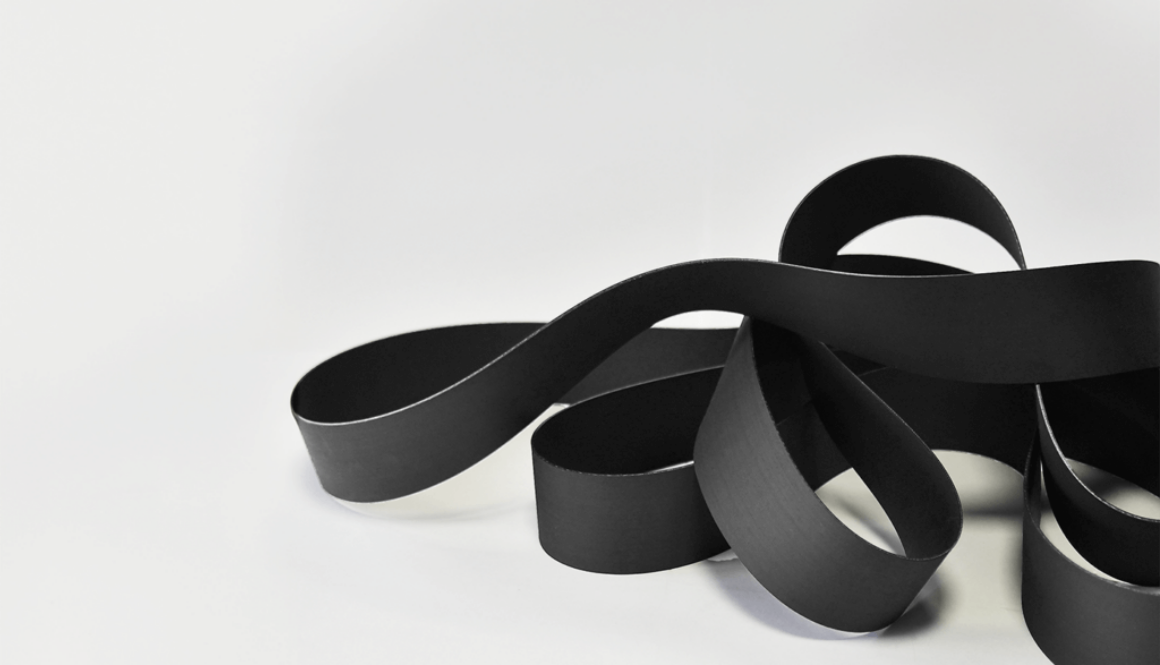 black NBR belts lying on white floor